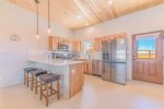 Sweet custom kitchen with bar seating, stainless appliances and shark clock